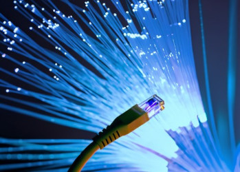 Ethernet cable in front of blue fibre optics
